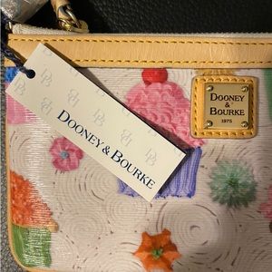 Brand New! Dooney & Bourke small multi color hand purse with red lining